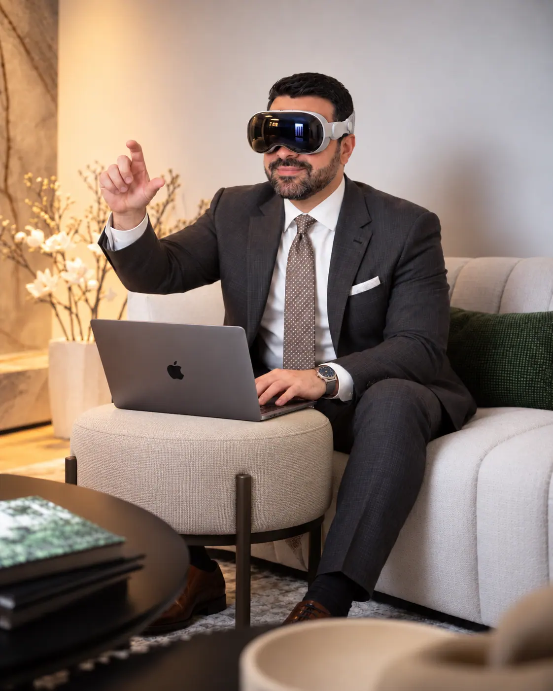 Hami Aryan at a laptop, wearing a mixed-reality headset