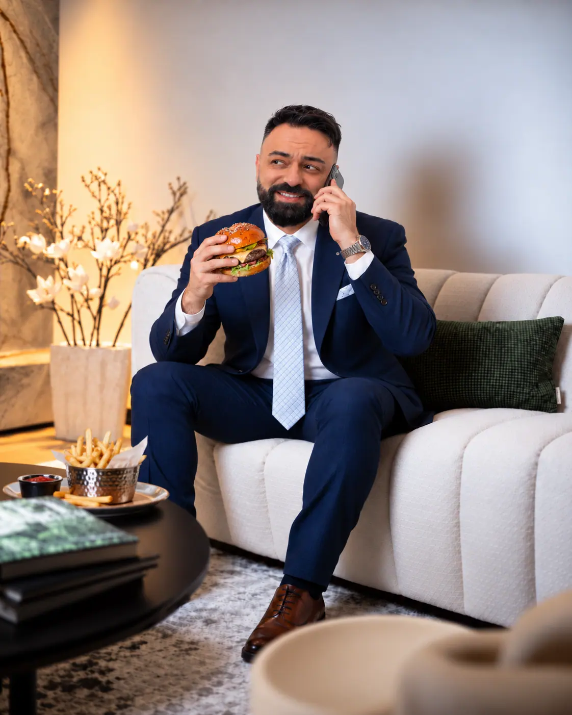 Niaz Eghrari taking a call over a burger
