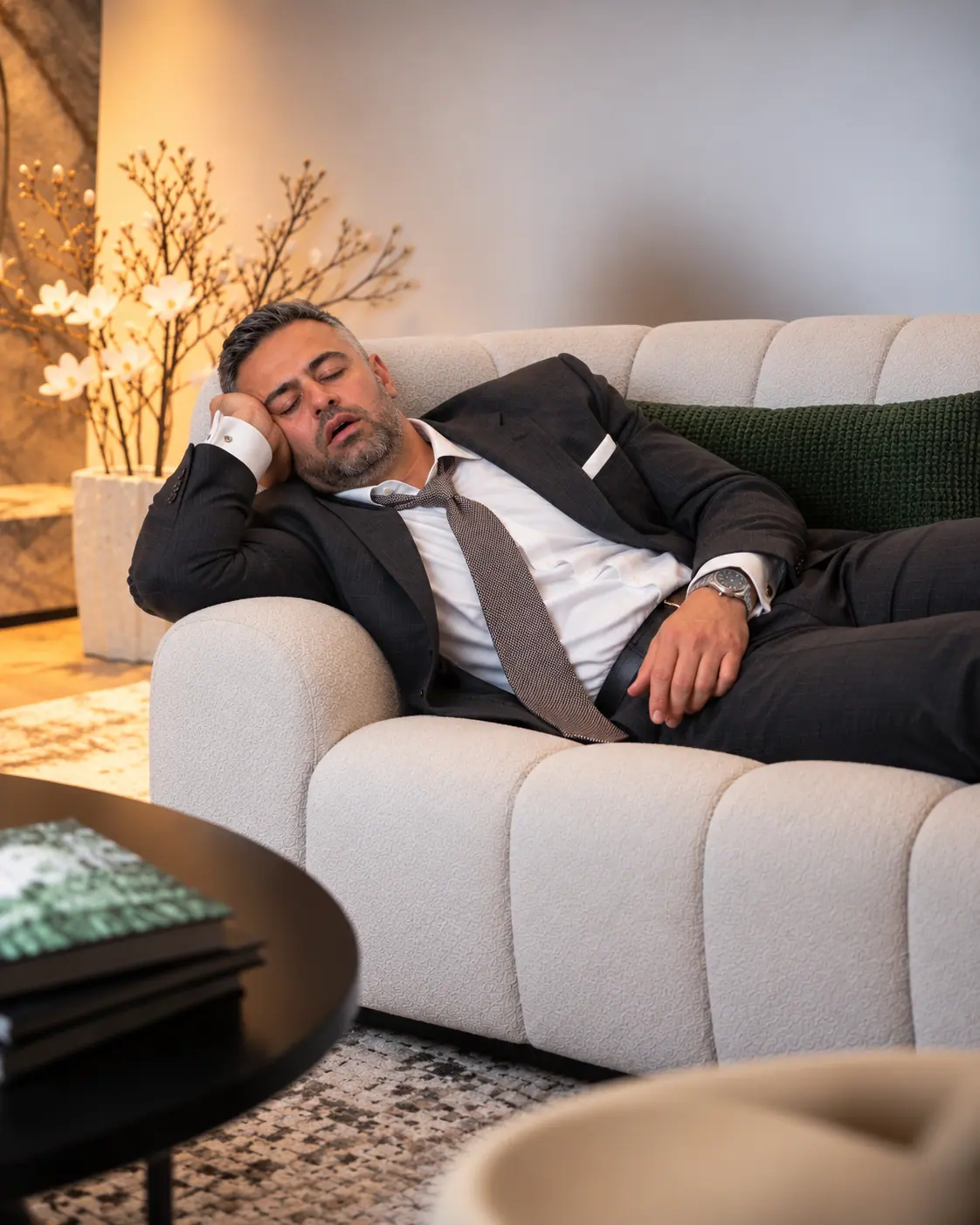 Sam Roshan taking a power nap on the sofa